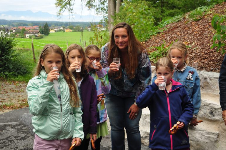 Kinder trinken Wasser und fördern nachhaltige Trinkgewohnheiten im Freien.